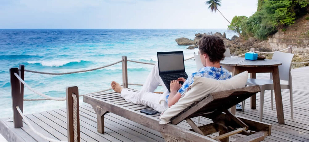 IV1-Digital-nomad-with-laptop-on-Balcony-1000x600-1